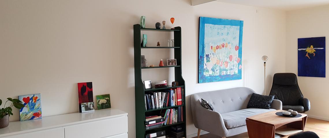 The living room, which is connected to the balcony and the kitchen