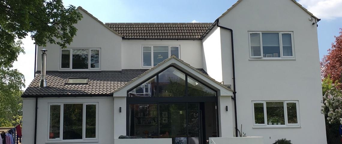 Rear of house. 3 steps or sloping grass to side. 